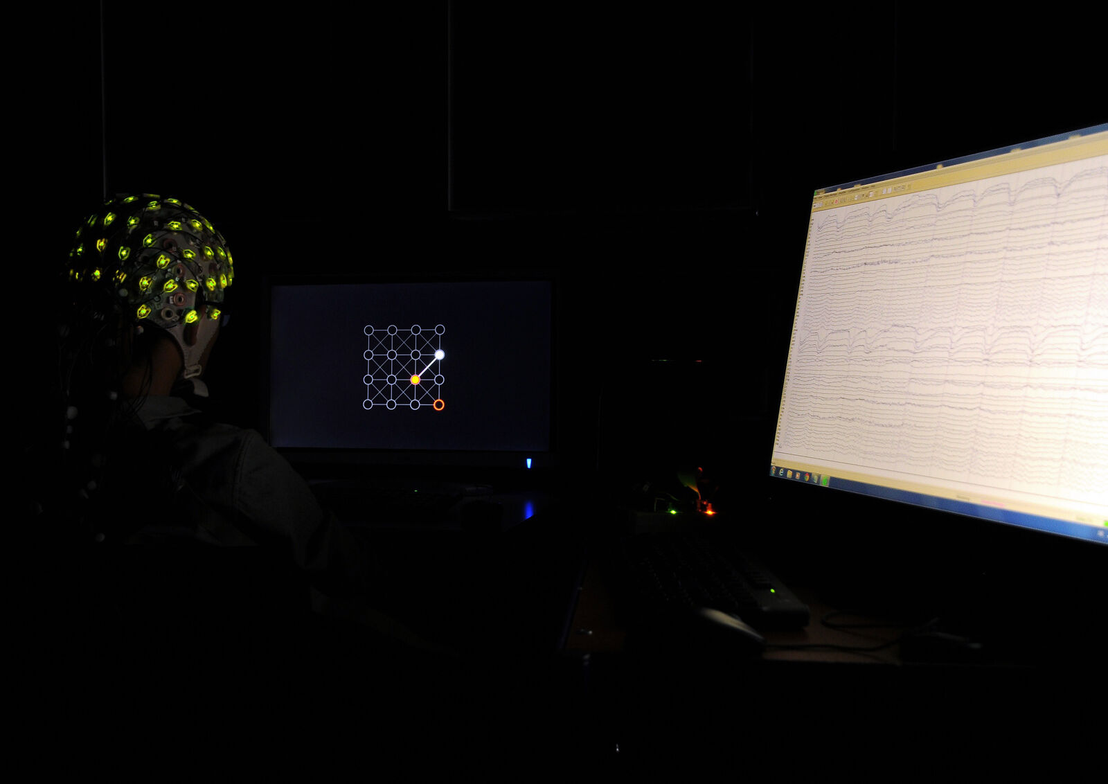 A person wearing an EEG cap takes part in a brain–computer interface experiment